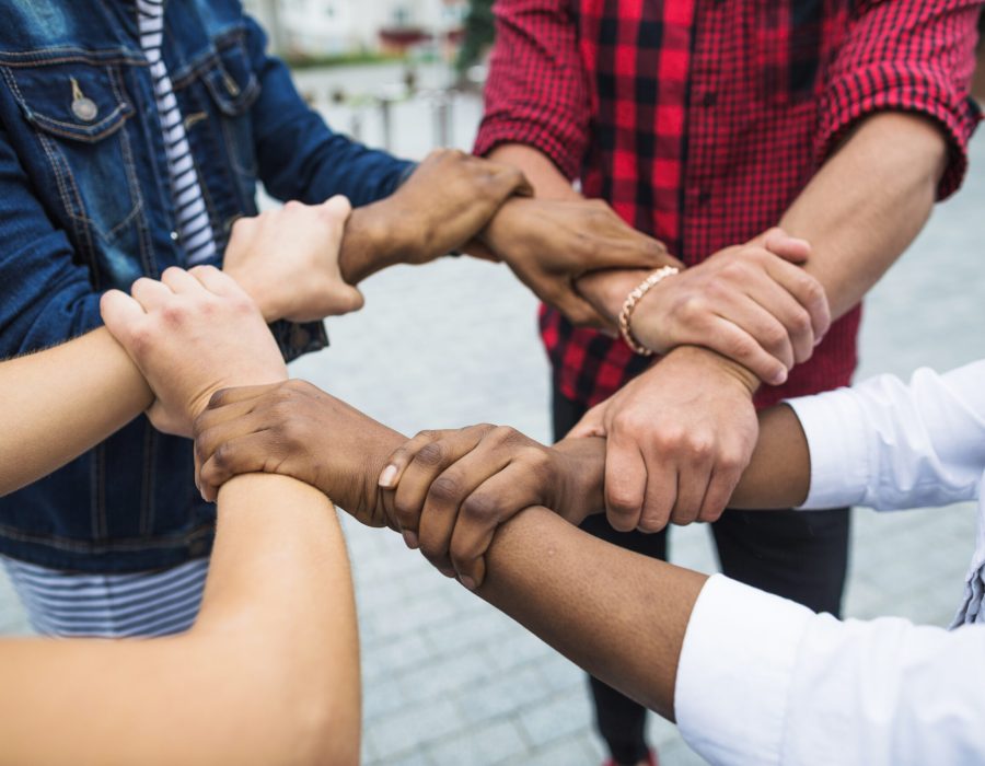 anonymous-multiracial-people-stacking-hands